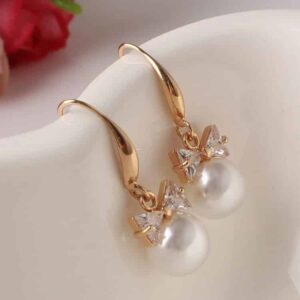 Christi Tasker Miami Bowtie Peal Earrings 3568289c-cdb3-56a0-b320-16793c1dc8f7.jpg Christi's super lightweight Crystal Bowtie Pearl Drop Earrings are classic must-have pearl earrings. Bowtie Peal Earrings