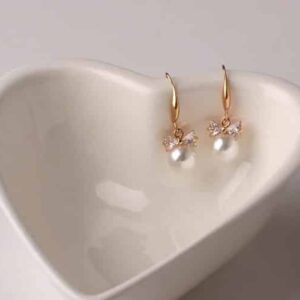Christi Tasker Miami Bowtie Peal Earrings 95d3bd01-6475-5dbc-b7a4-838aff5a0c0a.jpg Christi's super lightweight Crystal Bowtie Pearl Drop Earrings are classic must-have pearl earrings. Bowtie Peal Earrings