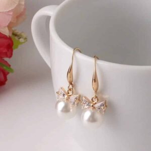 Christi Tasker Miami Bowtie Peal Earrings e7b01cba-ddc9-5552-8115-297d30aa90ad.jpg Christi's super lightweight Crystal Bowtie Pearl Drop Earrings are classic must-have pearl earrings. Bowtie Peal Earrings